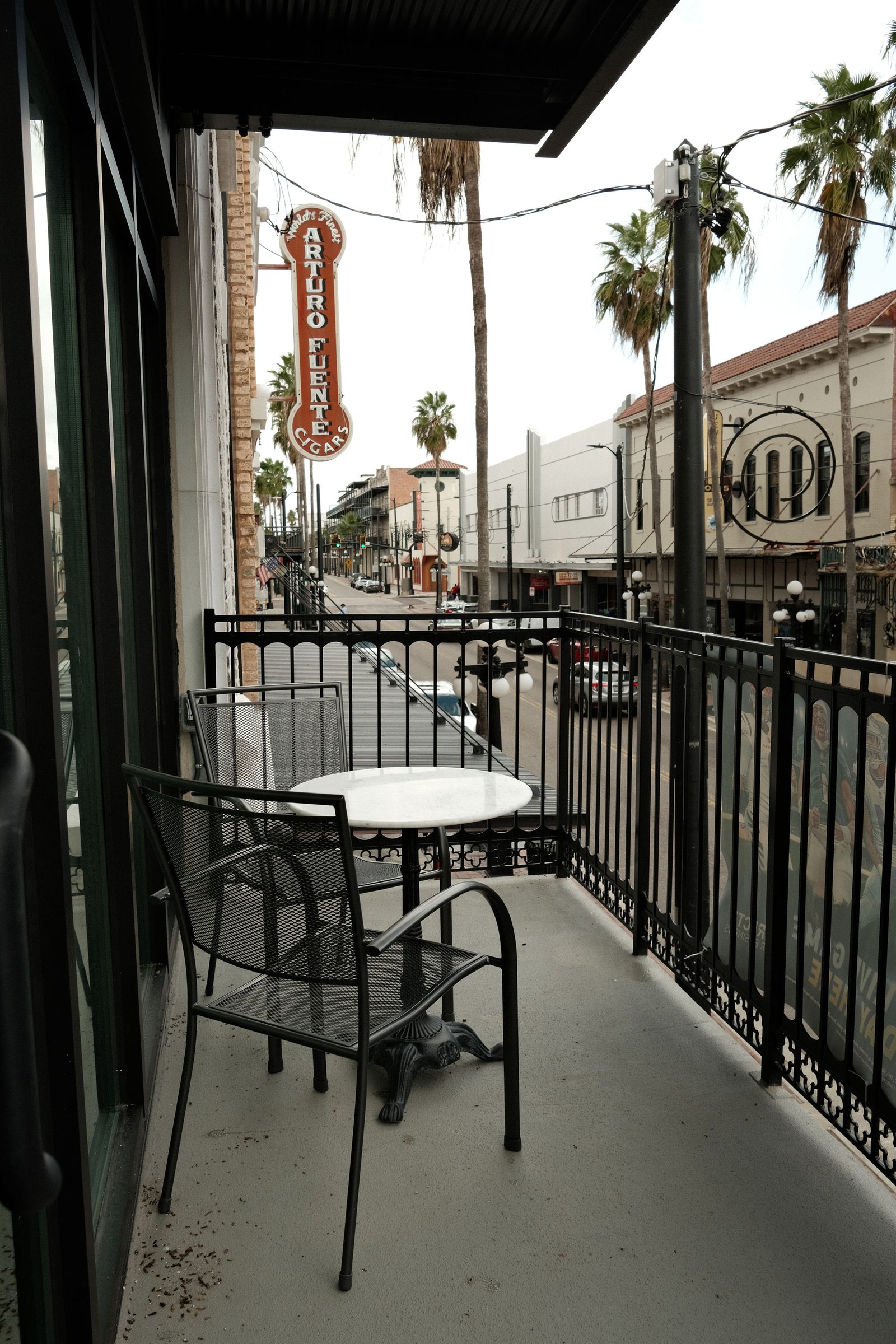 Arturo Fuente Balcony View - Wrought iron balustrades looking toward the historic Arturo Fuente building in Ybor City. | Sterling Suites Ybor City Tampa