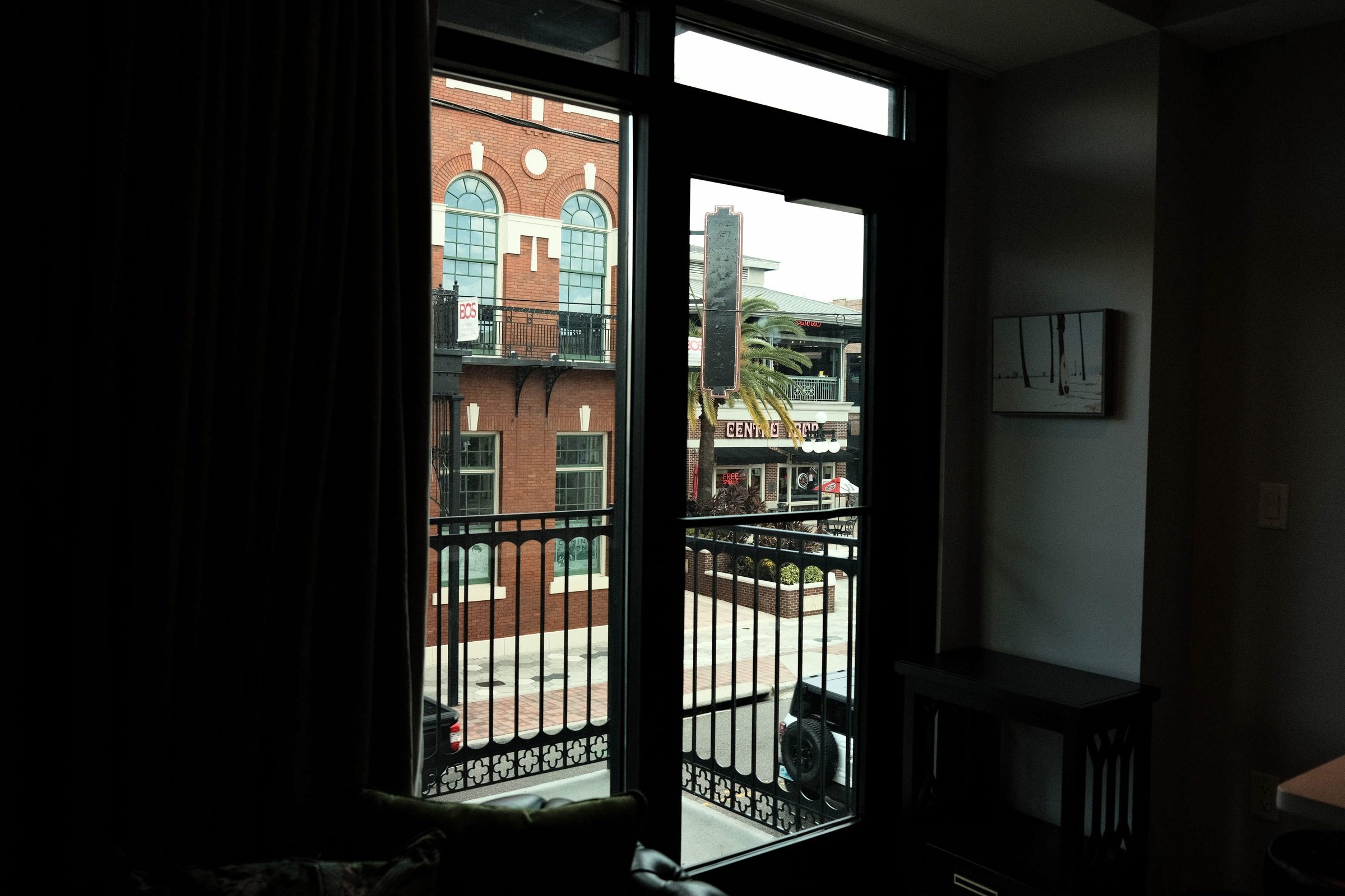 Sunlit Historic Windows - Floor-to-ceiling windows filling the open-concept living quarters with natural Florida sunlight. | Sterling Suites Ybor City Tampa
