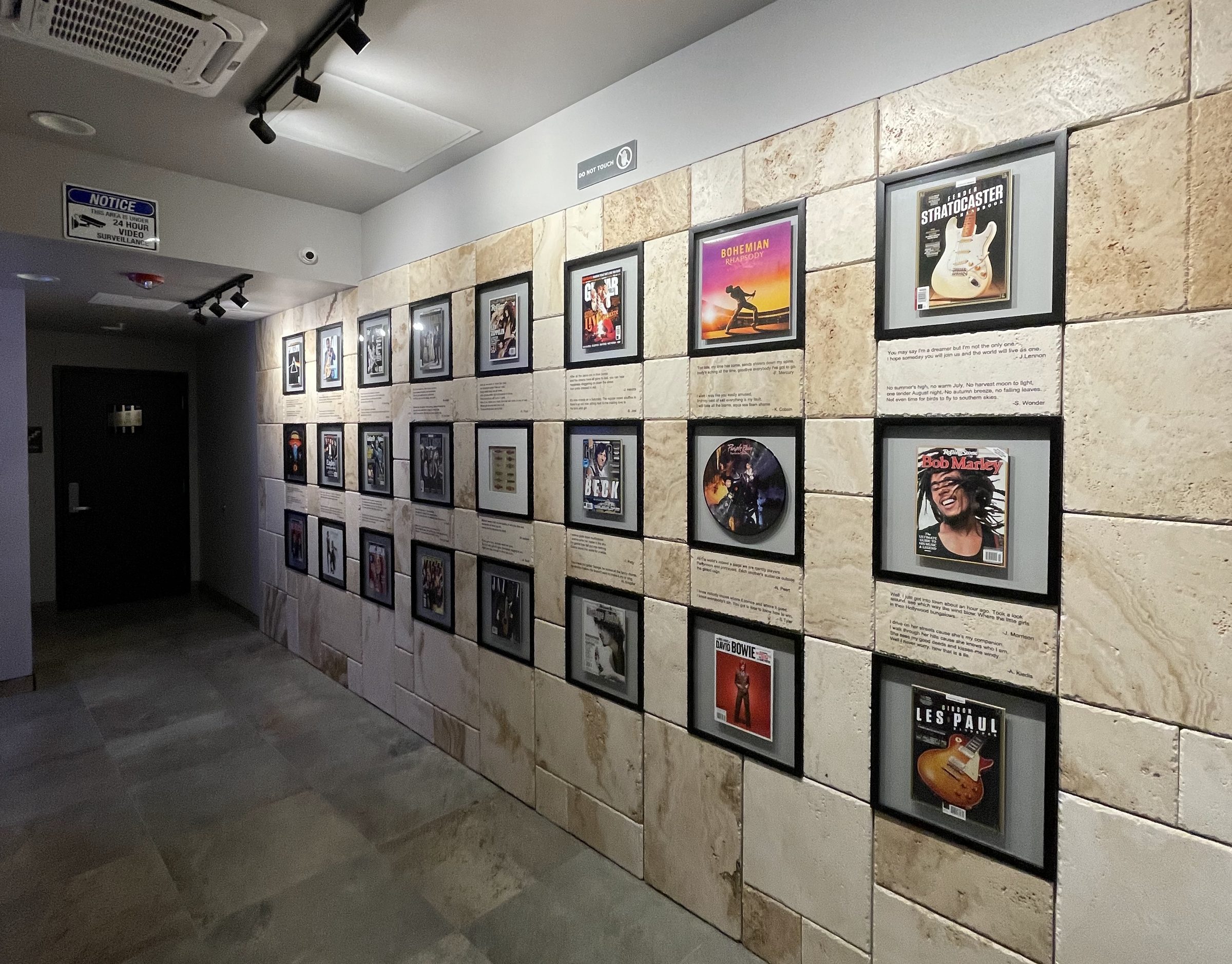 Gallery Hallway & Historic Bricks - Curated historic photography and exposed 19th-century brickwork along the guest corridor. | Sterling Suites Ybor City Tampa