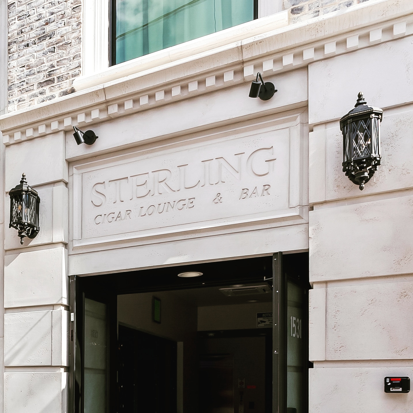 Sterling Transom Inscription - Gold leaf transom typography celebrating Ybor City’s storied cigar heritage. | Sterling Suites Ybor City Tampa